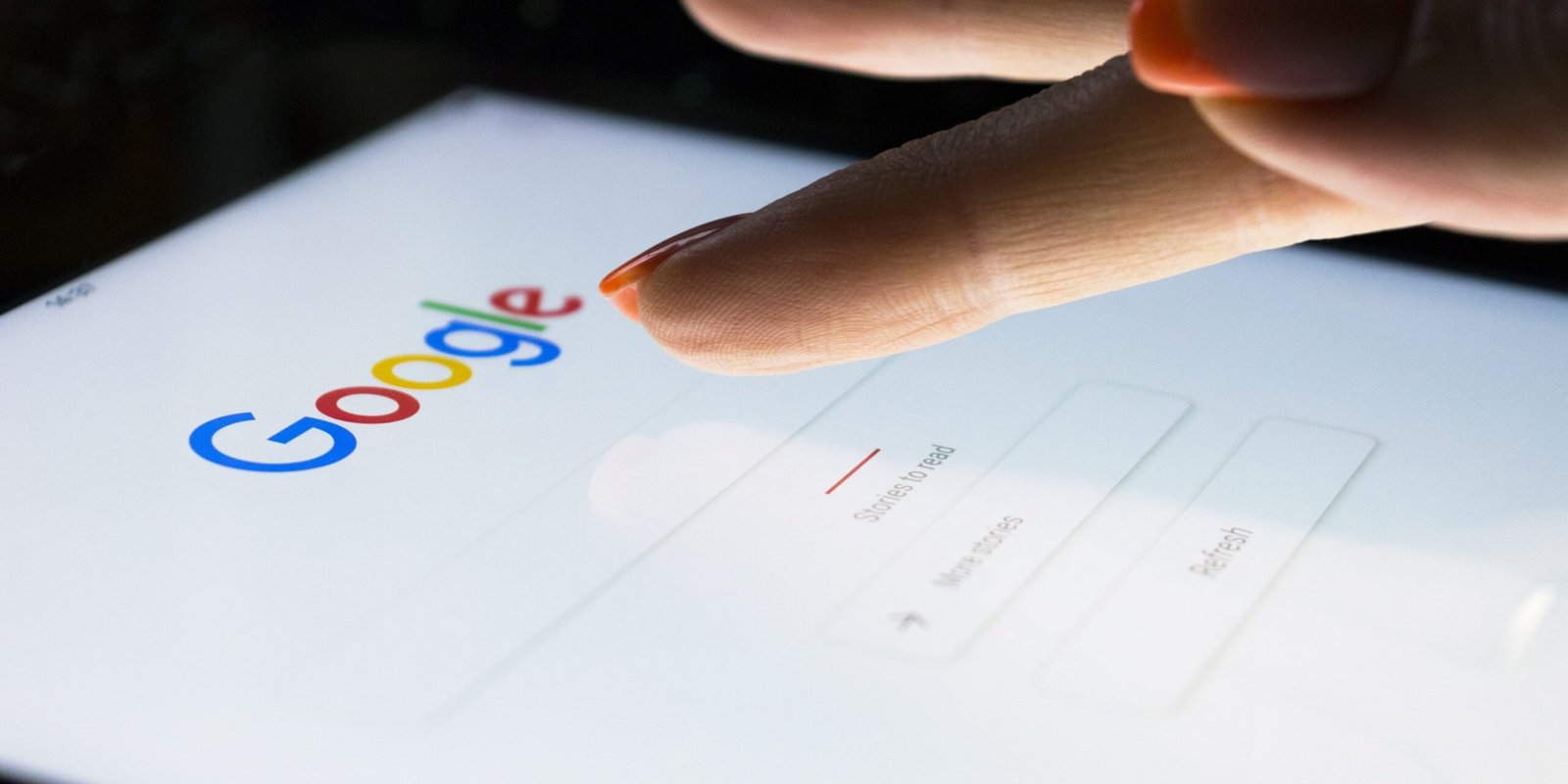 Sankt-Petersburg, Russia, November 8, 2017: A woman’s hand is touching screen on tablet computer iPad pro at night for searching on Google search engine. Google is popular Internet search engine