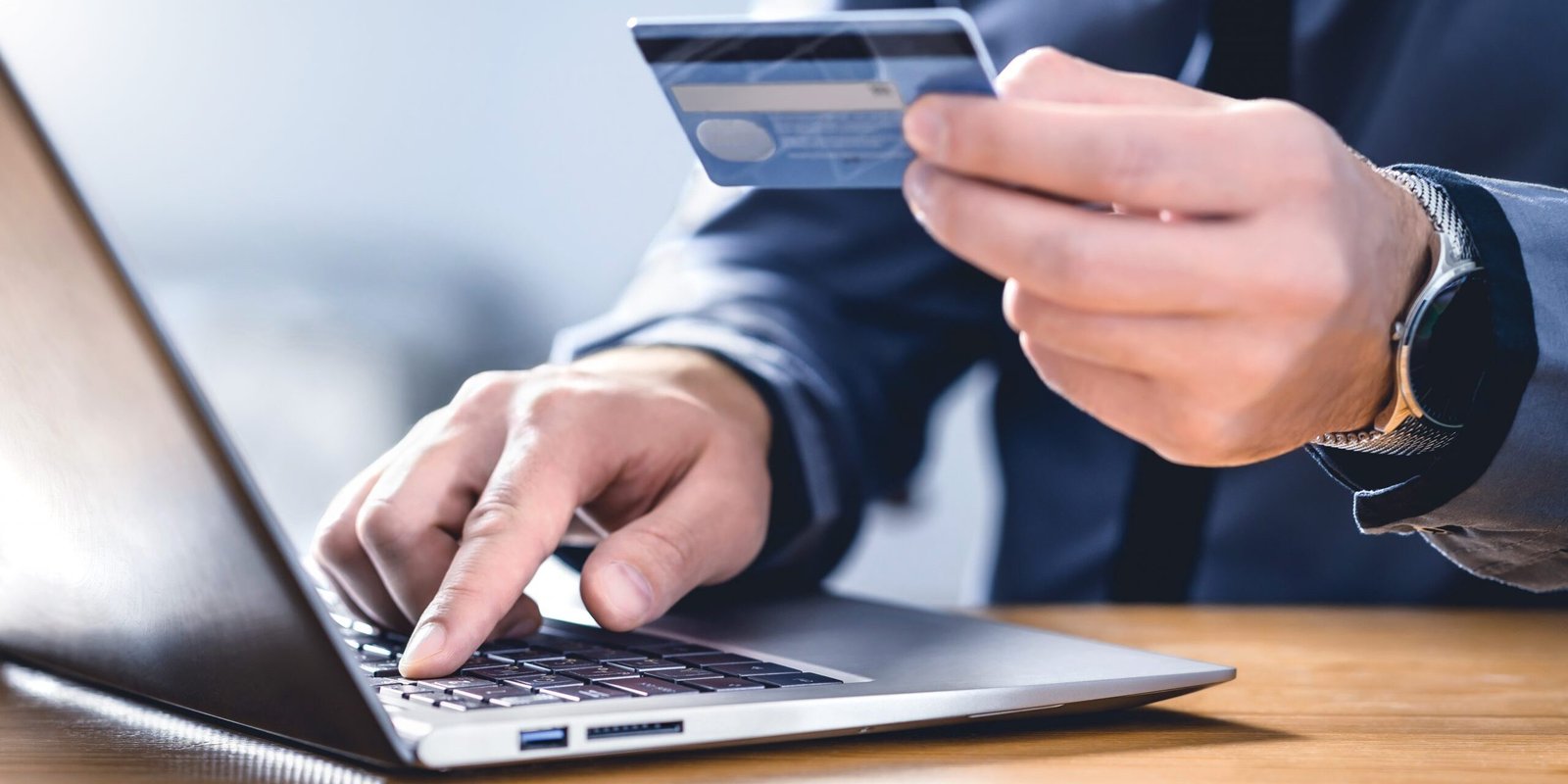 Safe online payment and electronic money transfer security. Pay with digital technology. Man using credit card and laptop to login to internet bank. Financial safety to prevent scam, threat and fraud.